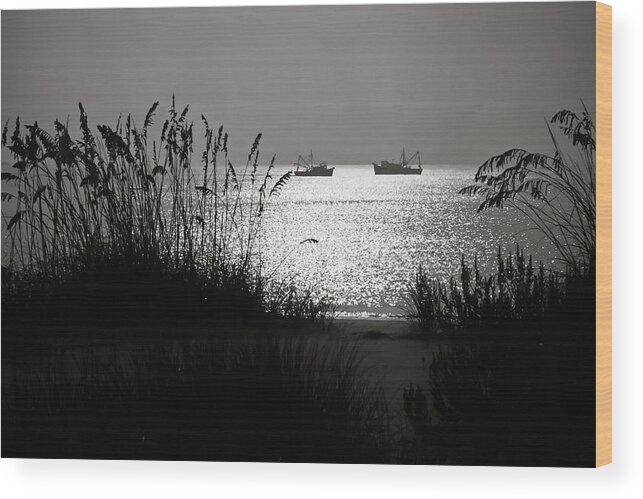 Tranquility Wood Print featuring the photograph Silhouettes Of Sea Oats And Shrimp Boats by Joseph Shields