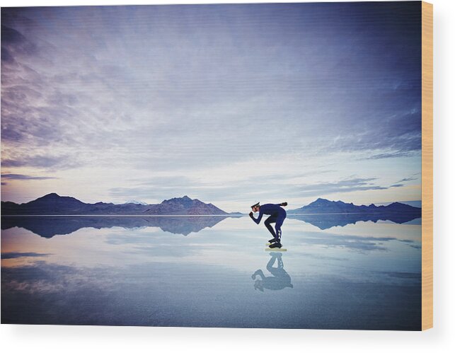 Scenics Wood Print featuring the photograph Speed Skater Skating On Calm Lake At by Thomas Barwick