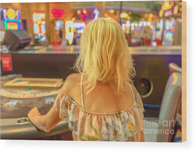 Las Vegas Wood Print featuring the photograph Woman gambling at blackjack table by Benny Marty