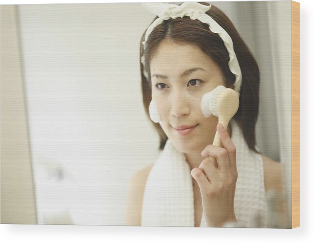 Material Wood Print featuring the photograph A woman washing her face #1 by Imagenavi