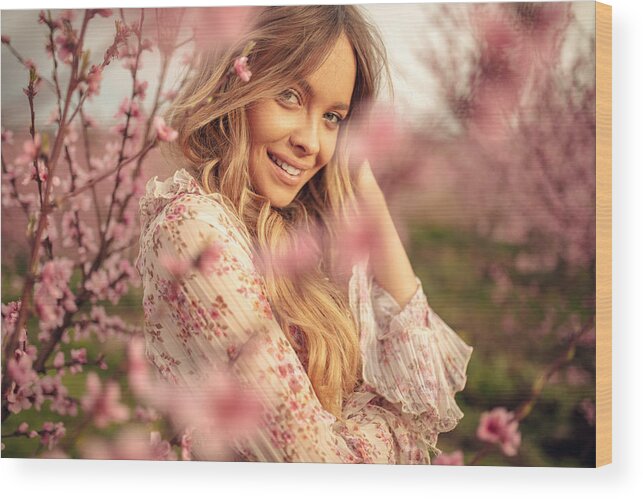 People Wood Print featuring the photograph Amazing young woman posing in apricot tree orchard at spring by Miljko
