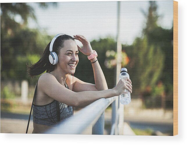 Music Wood Print featuring the photograph Fitness woman taking a break after running workout #1 by Zeljkosantrac