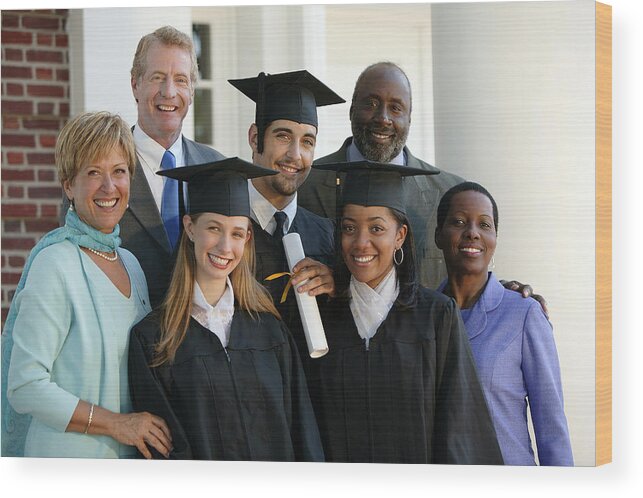 Young Men Wood Print featuring the photograph Graduates and parents #1 by Comstock Images