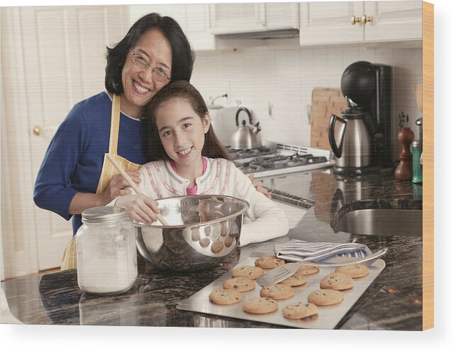 4-5 Years Wood Print featuring the photograph Grandmother and granddaughter baking cookies #1 by Comstock Images