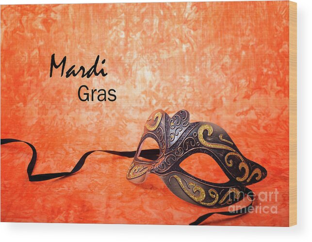 Black Wood Print featuring the photograph Mardi Gras mask on orange background. #1 by Milleflore Images