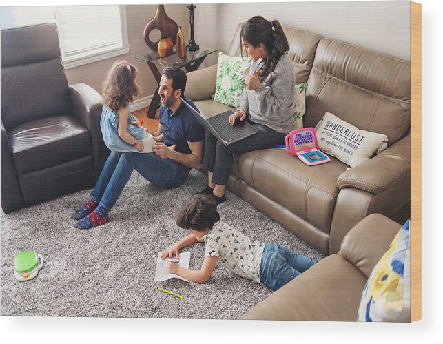 Working Wood Print featuring the photograph Quarantined family telecommuting with kids du to the covid-19 #1 by Lisegagne