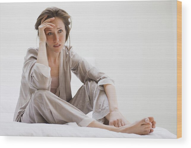 Problems Wood Print featuring the photograph Depressed woman in pajamas sitting in bed #2 by Tom Merton