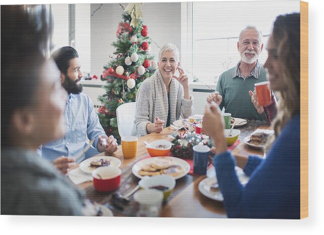 Mid Adult Men Wood Print featuring the photograph Family having breakfast on Christmas morning. #2 by Gilaxia