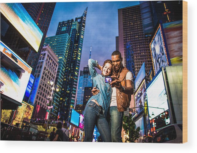 Young Men Wood Print featuring the photograph Mixed race couple walking around in New York City, taking selfies #2 by Itsskin