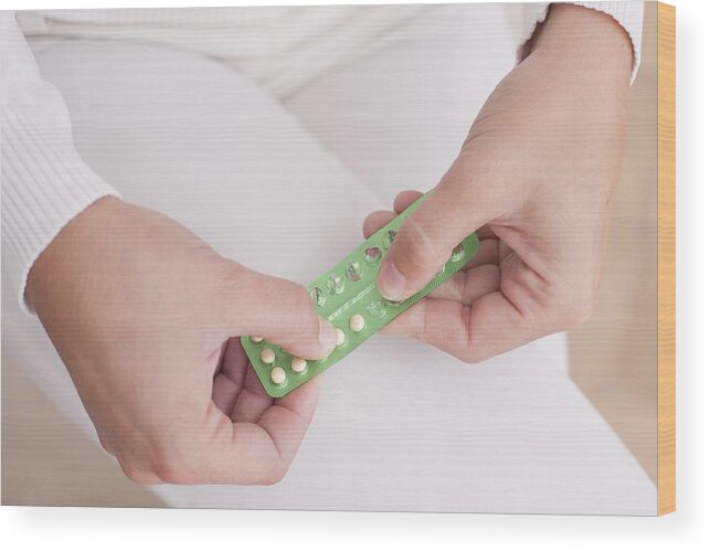 Prevention Wood Print featuring the photograph Woman holding contraceptive pills #6 by Science Photo Library