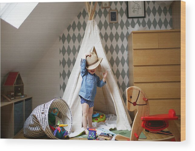 Holding Wood Print featuring the photograph A 2 years old boy playing in his bed by Catherine Delahaye