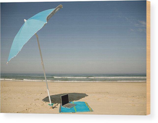 Shadow Wood Print featuring the photograph A laptop lying on a beach towel on a beach by Sean Russell