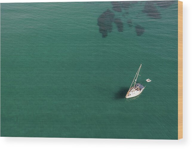 Anchored Wood Print featuring the photograph Aerial view of a luxury yacht anchored in the surface of the sea. Cyprus vacations by Michalakis Ppalis