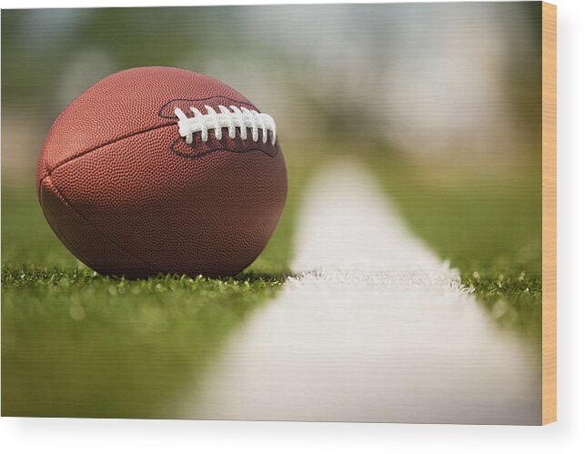Grass Wood Print featuring the photograph American football on the turf by Pgiam