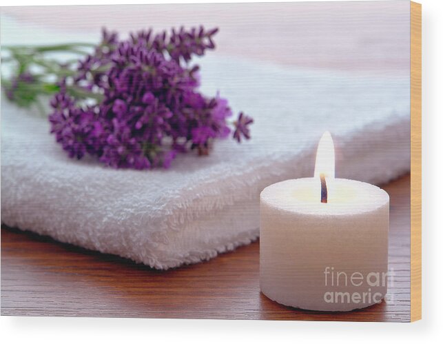 Aromatherapy Wood Print featuring the photograph Aromatherapy Candle with Lavender Flowers on White Bath Towel in by Olivier Le Queinec