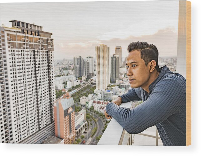 Rooftop Deck Wood Print featuring the photograph Asian Man Enjoying The Sunset View Over Bangkok by Davidf