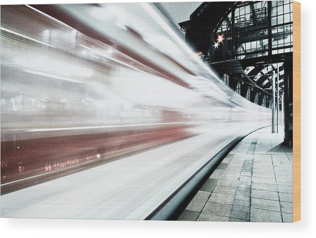 Berlin Wood Print featuring the photograph Blurred train at night leaving station by Bernd Schunack