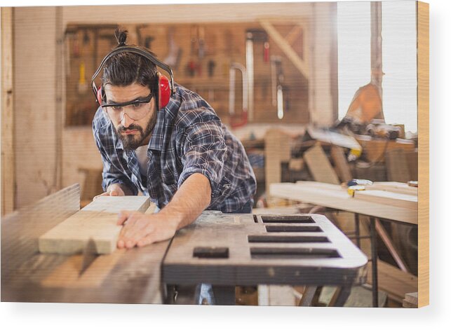 Working Wood Print featuring the photograph Carpenter cutting wooden plank by Obradovic