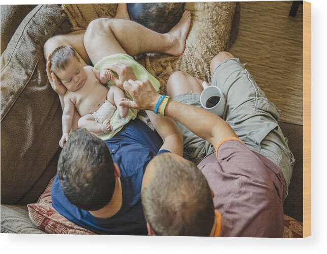 Pets Wood Print featuring the photograph Caucasian gay couple holding sleeping baby boy on sofa by Inti St Clair