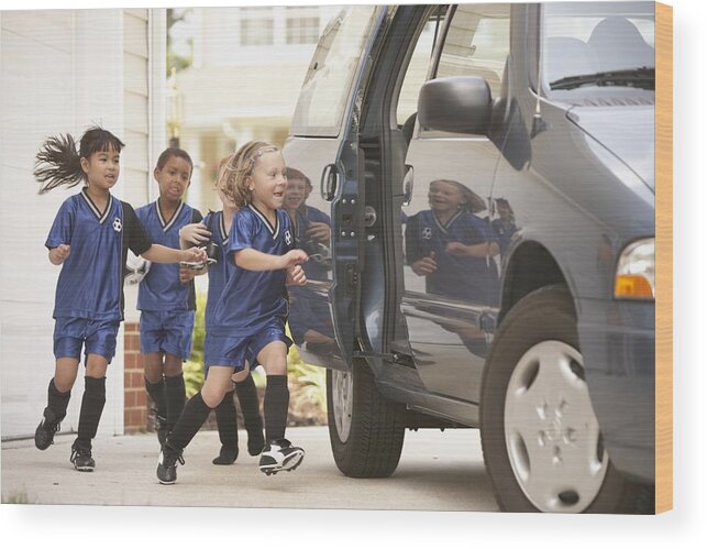 Soccer Uniform Wood Print featuring the photograph Children in soccer outfits getting into car by Ariel Skelley