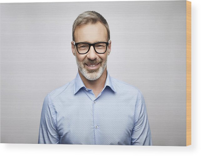 Expertise Wood Print featuring the photograph Close-up smiling male leader wearing eyeglasses by Morsa Images