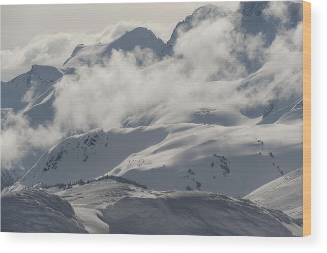 Scenics Wood Print featuring the photograph Clouds over snowcapped mountains by Fotosearch