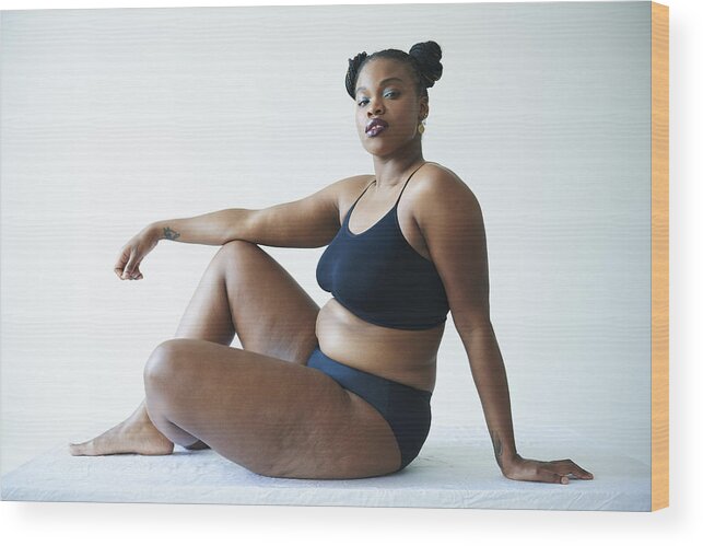 Curve Wood Print featuring the photograph Confident Curvy Woman Sitting And Looking To Camera by Tara Moore