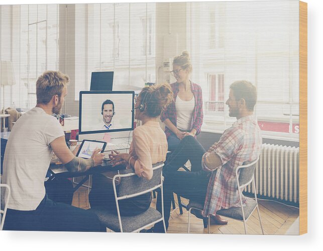 New Business Wood Print featuring the photograph Coworkers doing a video conference in the conference room by Johnkellerman