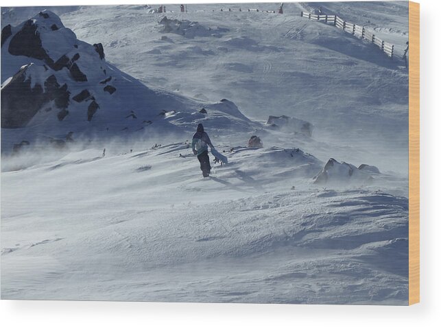 Skier Wood Print featuring the photograph Extreme winter sport. Young pro snowboarder walks uphill in the halfpipe snow park. Teenager in blue white and black jacket is struggling with the wind. Low Tatras in Slovakia by Vaclav Sonnek