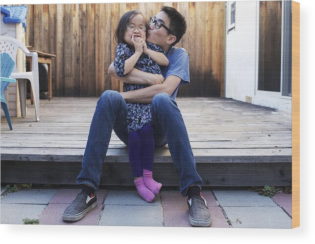 4-5 Years Wood Print featuring the photograph Father and daughter playfully hug and kiss by Joey Celis