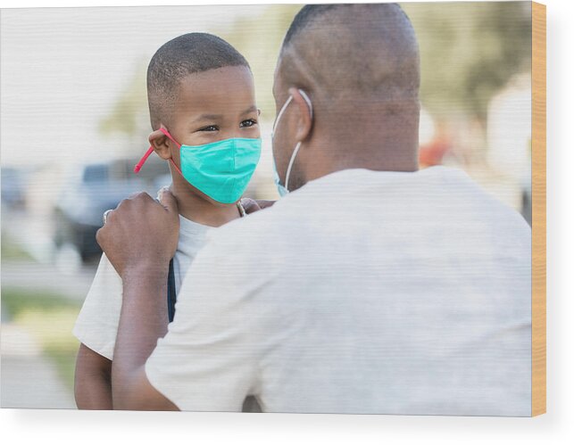 Protective Face Mask Wood Print featuring the photograph Father and elementary age son wear masks and say goodbye as father drops son off for first day back to school during time of coronavirus by Courtney Hale
