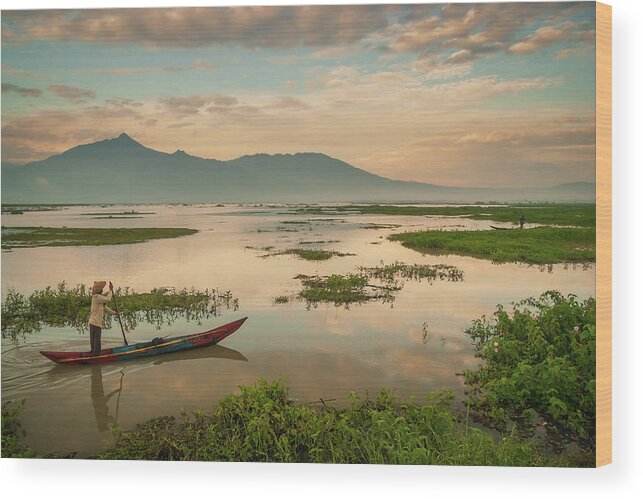 Boats Wood Print featuring the photograph Fisherman on his way in the early morning on lake Rawapening by Anges Van der Logt