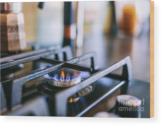 Gas Wood Print featuring the photograph Gas flames burning on kitchen stove top by Michal Bednarek