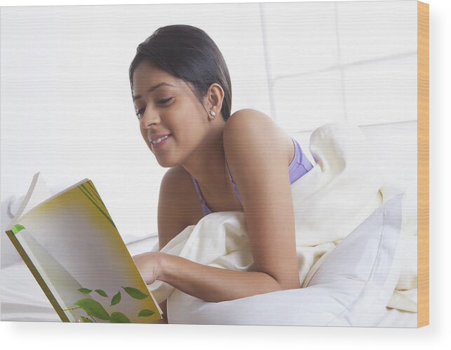 People Wood Print featuring the photograph Girl reading a book in bed by Ravi Ranjan