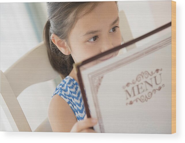 Tranquility Wood Print featuring the photograph Girl reading menu in restaurant by JGI/Jamie Grill