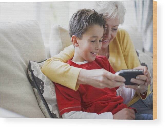 Explaining Wood Print featuring the photograph Grandmother and grandson playing video game by Paul Bradbury