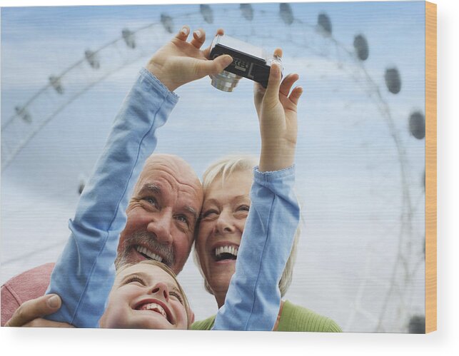 Capturing An Image Wood Print featuring the photograph Grandparents and Granddaughter with Digital Camera by Fuse