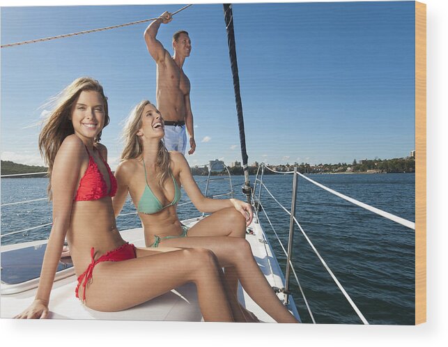 Sailboat Wood Print featuring the photograph Group of friends having fun on a yacht by Courtneyk