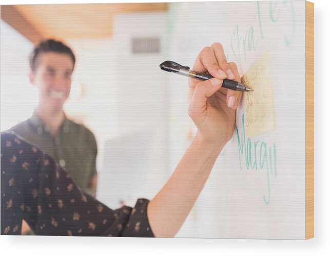 Young Men Wood Print featuring the photograph Hand of businesswoman writing on whiteboard adhesive notes by Heshphoto