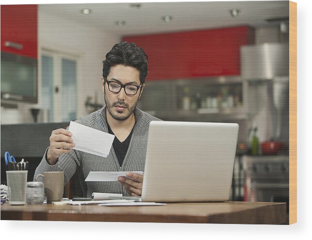 One Man Only Wood Print featuring the photograph Hispanic man paying bills on computer by Hill Street Studios