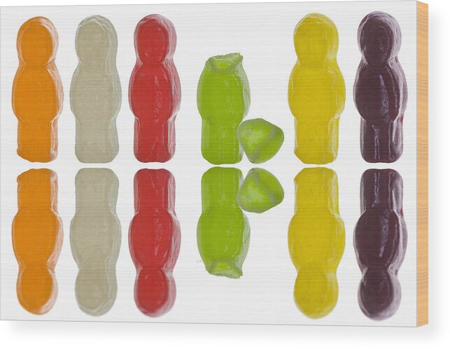 In A Row Wood Print featuring the photograph Jelly babies with one candy figure headless by Alex Bramwell