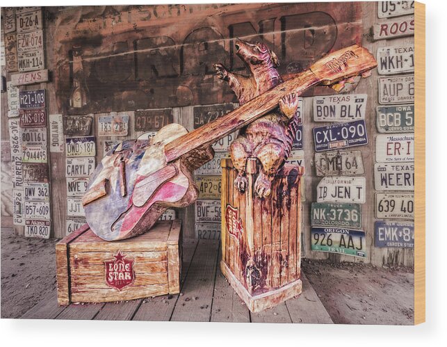 Dark Wood Print featuring the photograph Luckenbach's Guitar-Playing Armadillo by Andy Crawford