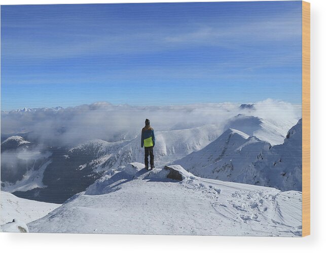 View Wood Print featuring the photograph Magical panorama on peak of Chopok with view to High Tatras and Dumbier. Young skier enjoy freedom and paradise looks. Man in colorful ski clothes stand on the edge of mountain and watchs landscape by Vaclav Sonnek