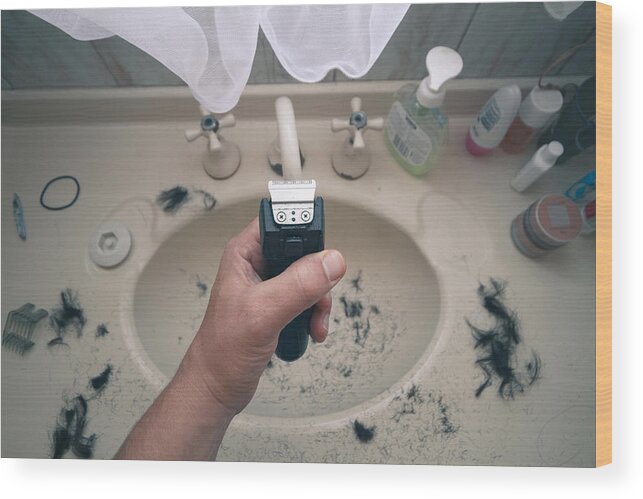Electric Razor Wood Print featuring the photograph Man holding electric shaver with hair all over sink by Photo by Joel Sharpe
