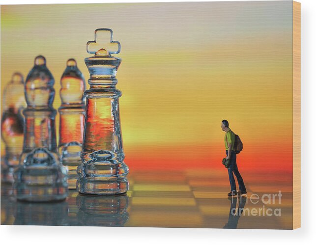 Rule Wood Print featuring the photograph Miniature figure people as businessman standing face to face with King chess piece on chessboard. Sunset background. Macro by Pablo Avanzini