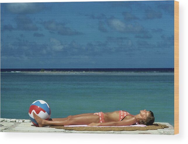 Fashion Wood Print featuring the photograph Model Lying on the Beach in a Polka Dot Bikini by Mike Reinhardt