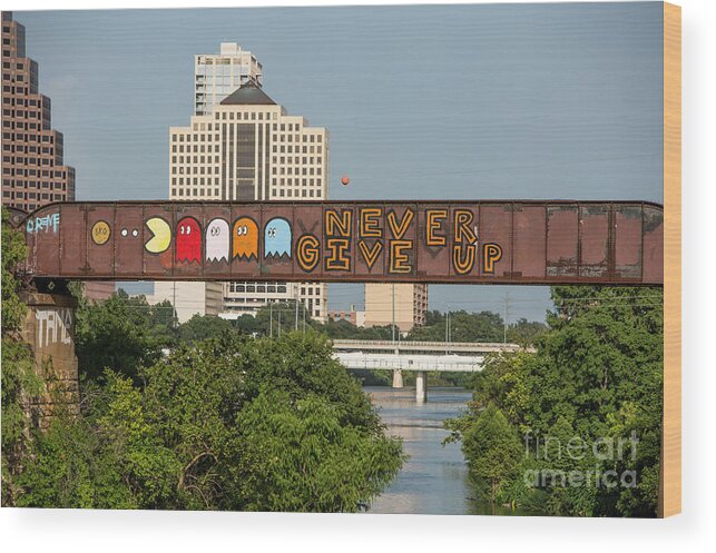 Never Give Up Wood Print featuring the photograph Never Give Up is a mural painting on the Austin Railroad Graffiti Bridge over Lady Bird Lake by Dan Herron