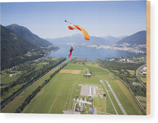 Parachuting Wood Print featuring the photograph Parachutist under canopy flying high in the sky by Oliver Furrer