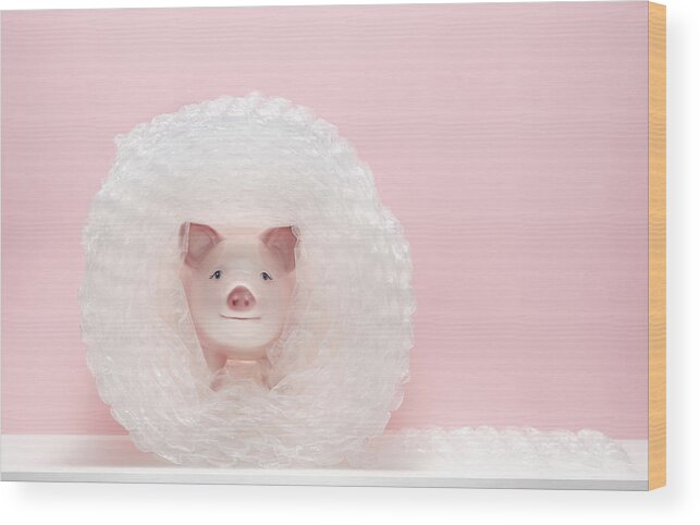 Security Wood Print featuring the photograph Piggy bank in bubble wrap by PM Images