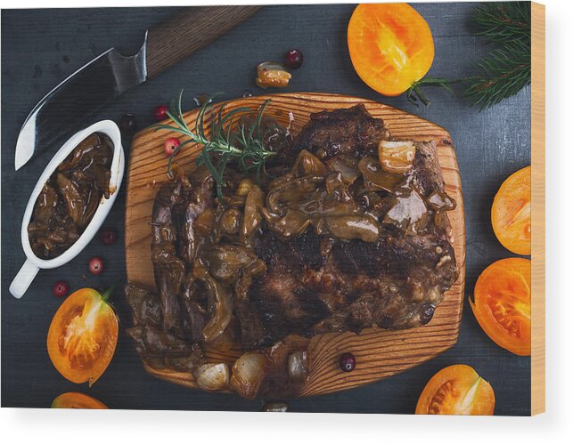 Tenderloin Wood Print featuring the photograph Roasted veal steak on board served with mushroom sauce viewed from above, Christmas dinner by Istetiana